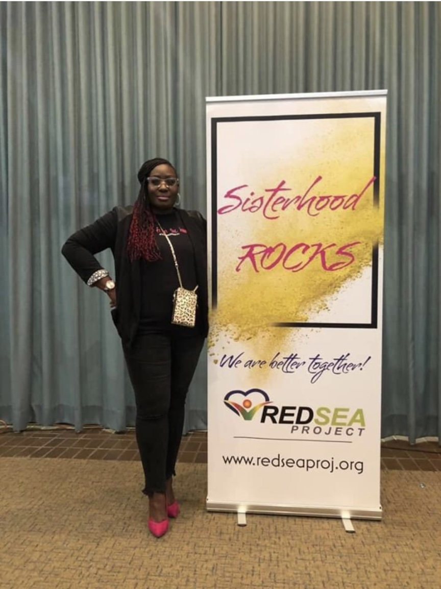 Red Sea Project representative beside the Sisterhood ROCKS event banner
