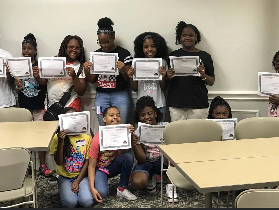 Youth participants holding certificates at an event